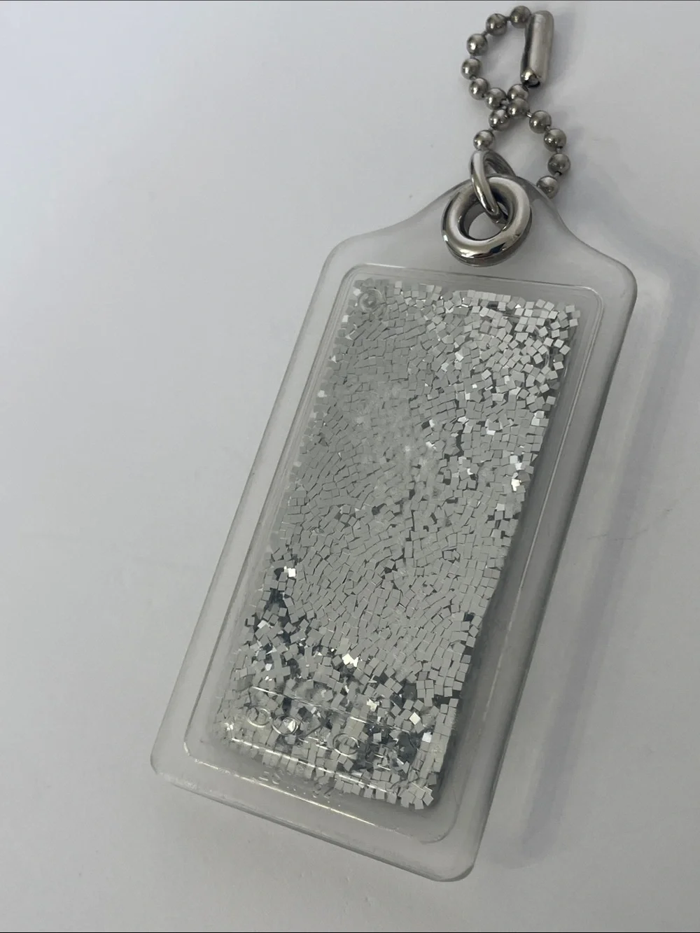 Coach Liquid Glitter Acrylic Hang Tag Clear | Silver